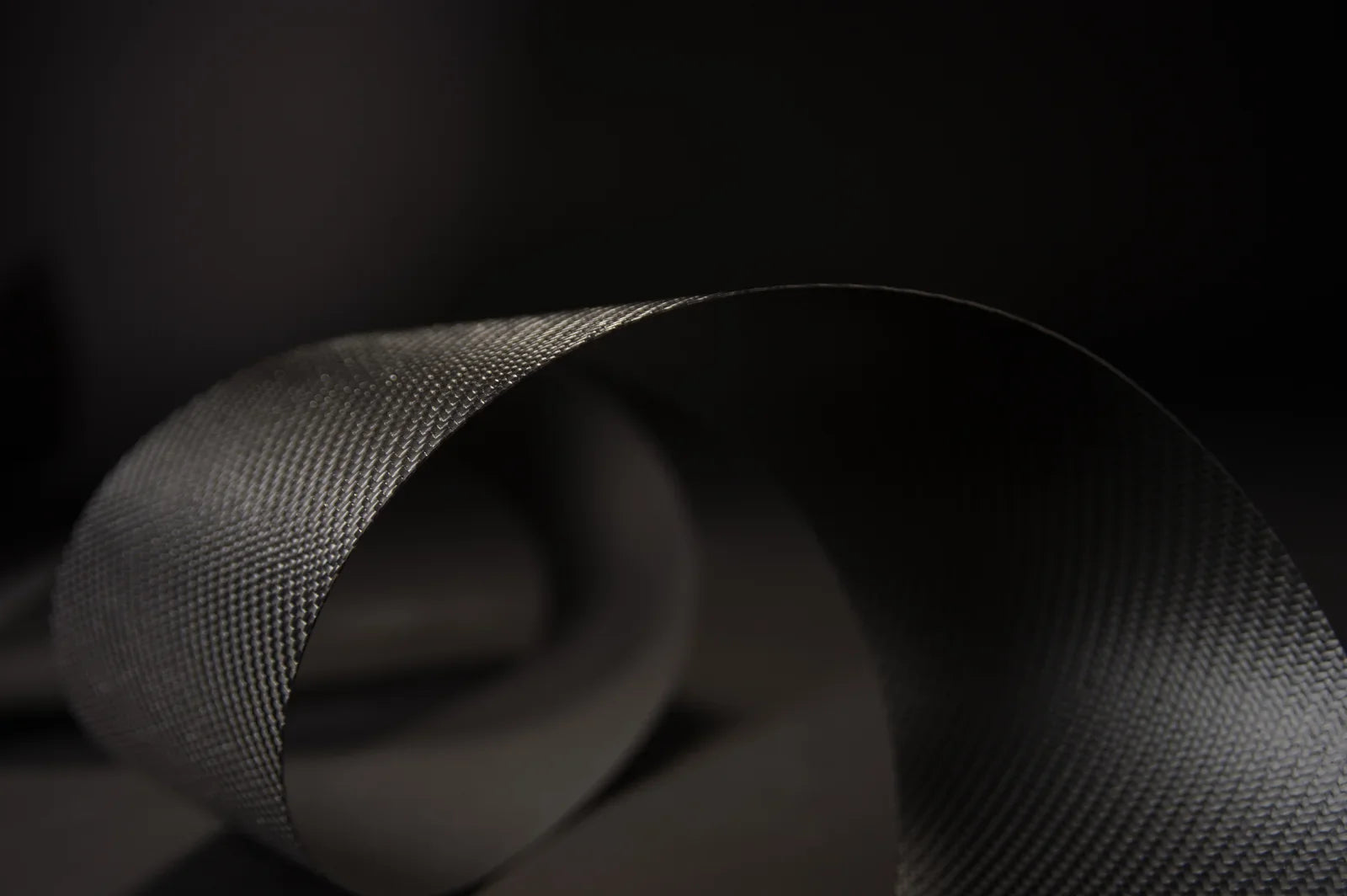 Genuine Carbitex OmniFlex flexible carbon fiber textile, a named material with a verifiable specification, the opposite of a premium adjective