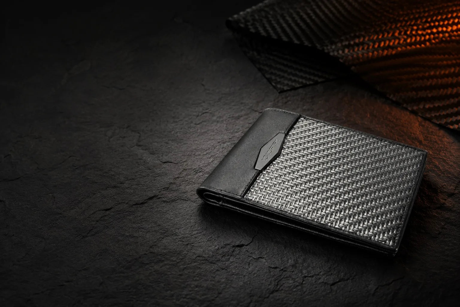 Carbon fiber vs aluminum wallets - COLDFIRE carbon fiber bifold wallet on dark slate stone